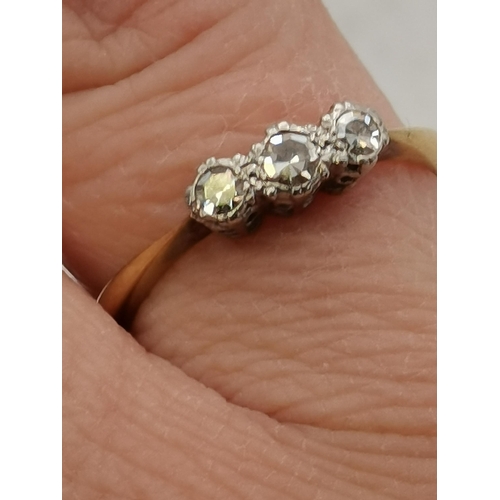 394 - A 9 carat gold and platinum three-stone ring, set with three white stones. Ring size O, 2.2g gross, ... 