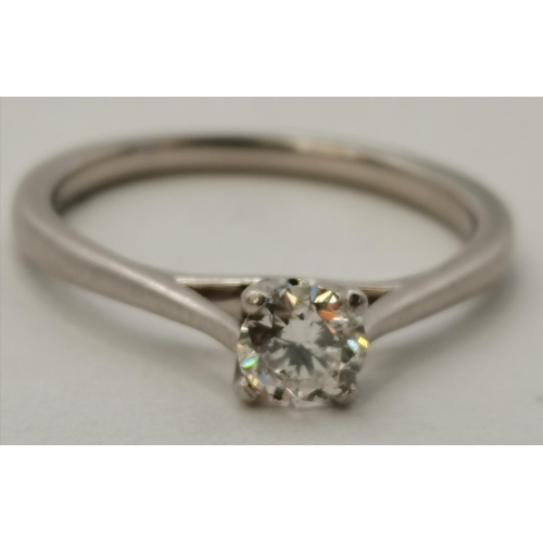 396 - A platinum and diamond solitaire ring, approx. 0.3ct, in a claw setting to pierced shoulders. Ring s... 