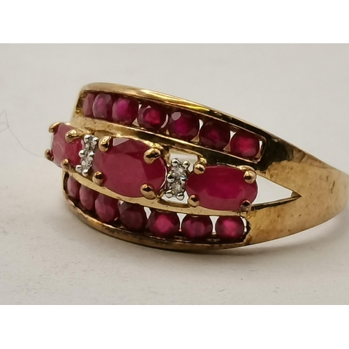 408 - Cocktail ring with 3 rows of red (possibly Ruby) stones with 2 small white stones set in 9ct Gold st... 