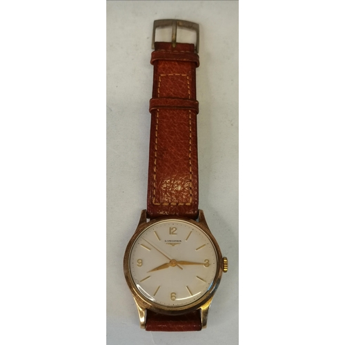 426A - A 9 carat gold gent's Longines strap wristwatch, the cream 28mm dial signed LONGINES, with gilt Arab... 