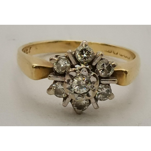 450H - An 18 carat gold diamond cluster ring, the seven stones set as a flowerhead, hallmarked, stamped '75... 