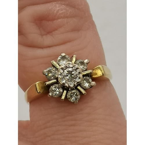 450H - An 18 carat gold diamond cluster ring, the seven stones set as a flowerhead, hallmarked, stamped '75... 