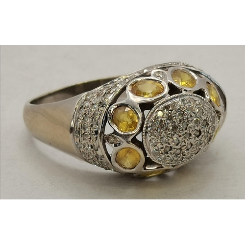 450K - A 14 carat white gold cocktail ring, pierced oval, set with citrines and white stones, stamped '14K'... 