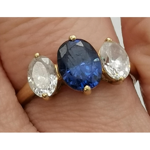 450O - A 14 carat gold three-stone ring, an oval blue topaz between two oval crystals, hallmarked, stamped ... 