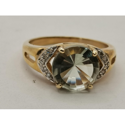 466 - A 9 carat gold green amethyst and diamond ring, the central stone with five diamonds either side, wi... 