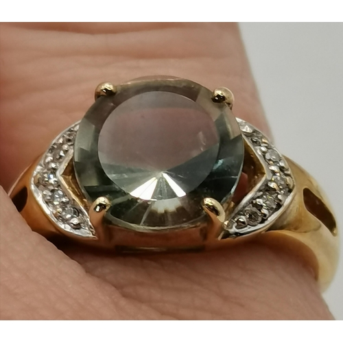 466 - A 9 carat gold green amethyst and diamond ring, the central stone with five diamonds either side, wi... 