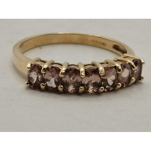 468 - A 9 carat gold pink sapphire ring, set with seven stones, with COA. Ring size Q, stated total sapphi... 