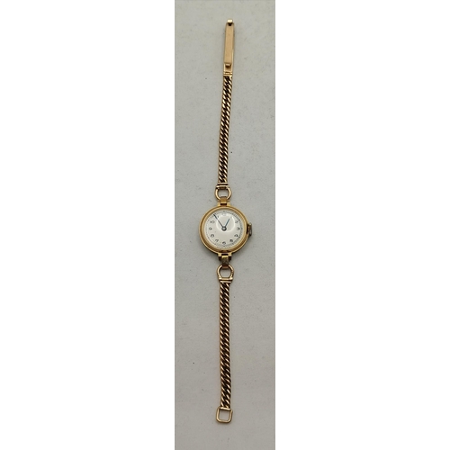 472A - A 9 carat gold lady's bracelet wristwatch, the 15mm cream circular dial unsigned, with Arabic numera... 