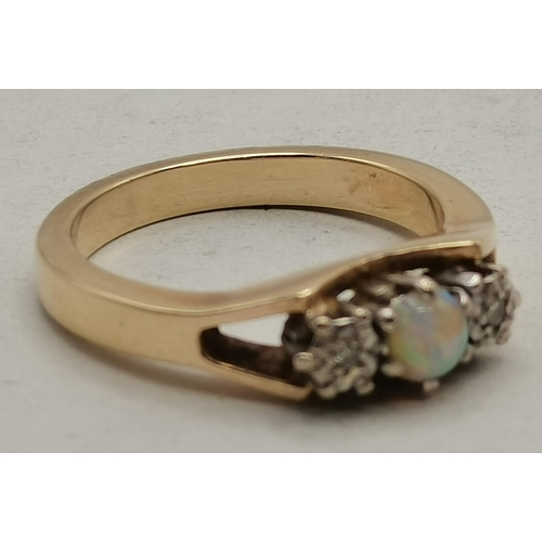 474B - A 9 carat gold cluster ring, the central blue stone surrounded by eight small white stones, in a fan... 