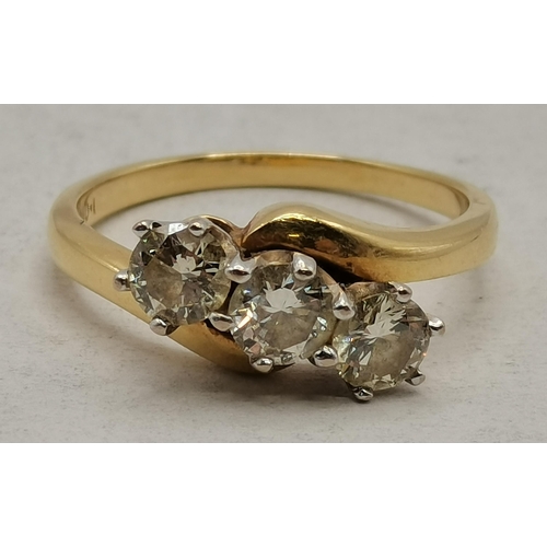 475 - An 18 carat gold diamond three-stone crossover ring, marked '750'. Ring size Q, 4.7g, with receipt a... 