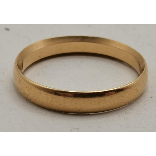 475C - An 18 carat gold band ring, hallmarked and stamped '18'. Ring size R1/2, 3.6g