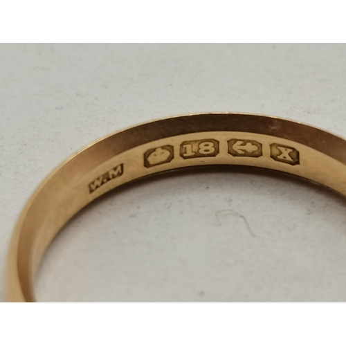 475C - An 18 carat gold band ring, hallmarked and stamped '18'. Ring size R1/2, 3.6g