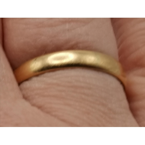 475C - An 18 carat gold band ring, hallmarked and stamped '18'. Ring size R1/2, 3.6g