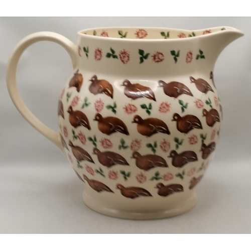 278 - An over-sized pottery serving jug by Brixton Pottery, the cream ground sponge decorated with brown b... 