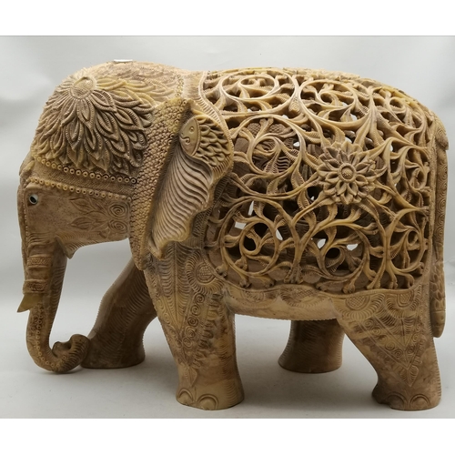 516 - A soapstone carved Asian elephant model, three in one, the ornately pierced back of the largest reve... 