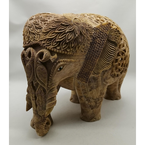 516 - A soapstone carved Asian elephant model, three in one, the ornately pierced back of the largest reve... 