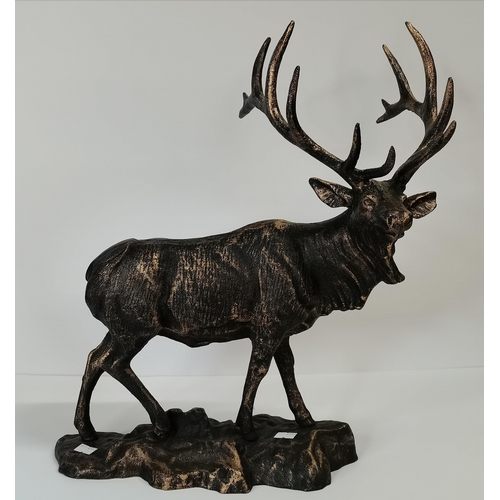 519 - A metal model of an Imperial stag, bronzed steel, the deer standing on a naturalistic rocky ground, ... 