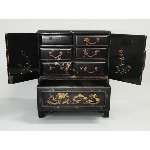 522 - A Japanese black lacquered tabletop cabinet, 19th Century, with gilded decoration of foliage and bir... 