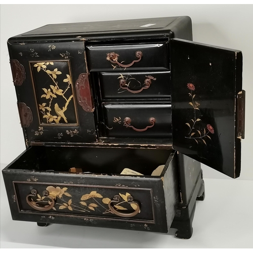 522 - A Japanese black lacquered tabletop cabinet, 19th Century, with gilded decoration of foliage and bir... 