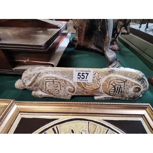 557 - A Chinese large jade pig, carved recumbent, with character marks to each limb. 29.5cm long