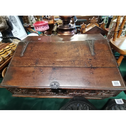 559 - A carved oak bible box, 18th Century, with sloping two-plank hinged cover, panel to front engraved w... 