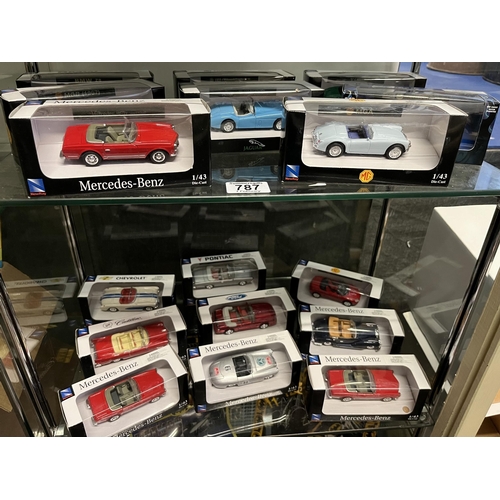 787 - A collection of die-cast model vehicles, in original display cases, 1:43 scale, including MG, Jaguar... 