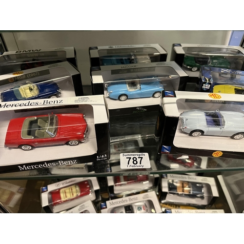 787 - A collection of die-cast model vehicles, in original display cases, 1:43 scale, including MG, Jaguar... 