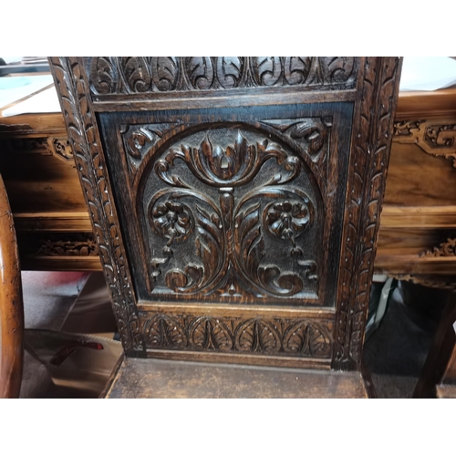 656 - 2 x early oak hall/ church chairs with carved decoration