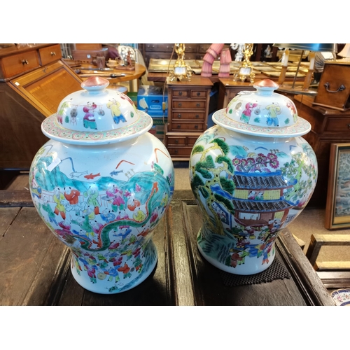 672 - A good pair of Chinese tea jars 45cm high decorated with trees and people