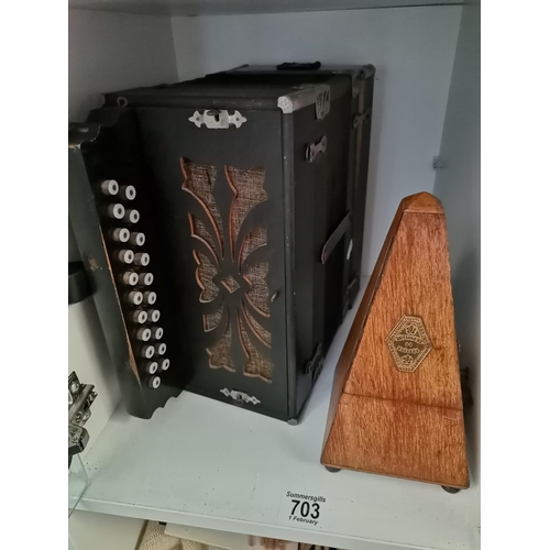 703 - A button accordion, together with a French metronome 