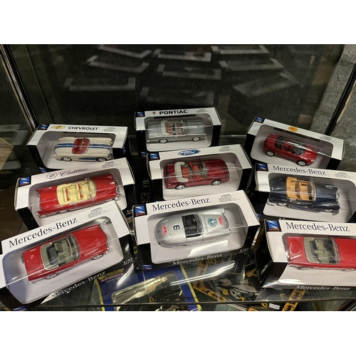 787 - A collection of die-cast model vehicles, in original display cases, 1:43 scale, including MG, Jaguar... 