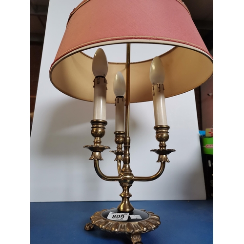 809 - A brass three-light table lamp, with three branches issuing from the central column, the shaped circ... 