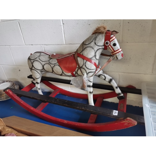 814 - A child's wooden and papier-mâché rocking horse, dapple grey, with leather ears and tack. Approx. 64... 