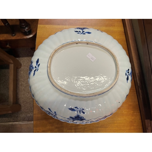 193 - A large blue and white ceramic bowl, 19th Century, oval with fluted sides, decorated in the Chinese ... 