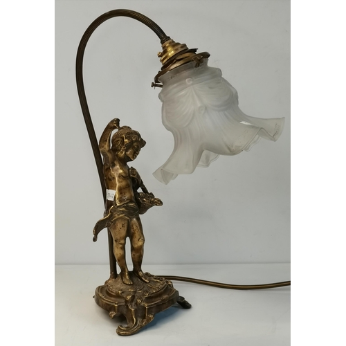 16 - A French figural brass table lamp, with a maiden holding a basket on her left arm, on a three-footed... 