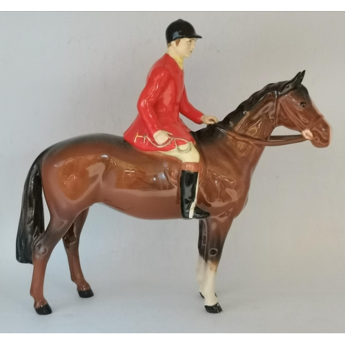 174 - A Beswick huntsman (a/f) and six foxhounds. (7)