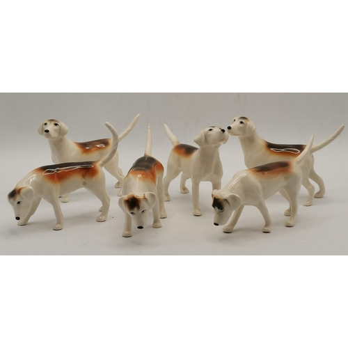 174 - A Beswick huntsman (a/f) and six foxhounds. (7)