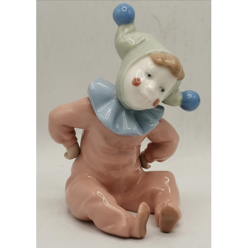 184 - A group of three Nao porcelain child figures, as infant jesters. (3) Tallest 13cm high