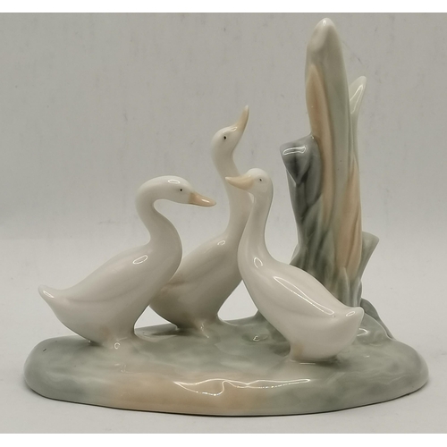 185 - Two Nao porcelain animal figure groups of geese and a hen and chicks, together with a Lladro group o... 