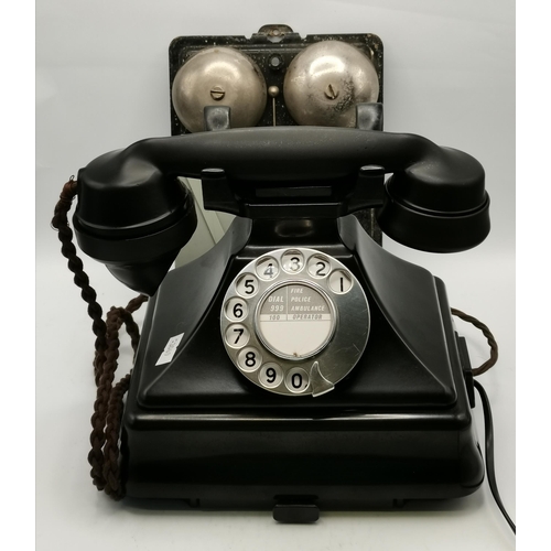 23 - A Bakelite rotary dial telephone; together with the internal mechanism for another telephone, stenci... 