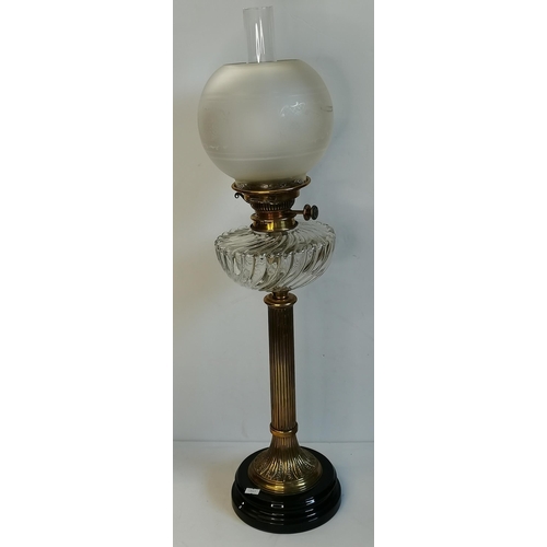 25 - Two Victorian glass and brass oil lamps, one with black glass body and reservoir with white enamel p... 