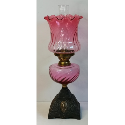 26 - A group of cranberry glassware comprising a Victorian oil lamp with square brass base; a Victorian l... 