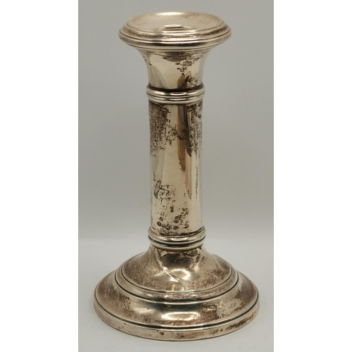 353 - A small group of mixed silver, early 20th Century, comprising a candlestick, filled; a square cigare... 