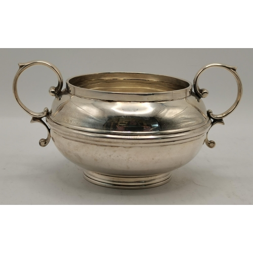 360 - An Edwardian silver twin-handled sugar bowl by William Neale & Son, Birmingham 1907, squat circular ... 