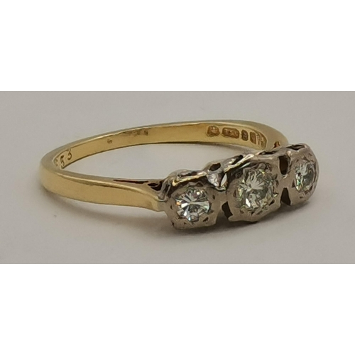 393 - An 18 carat gold three-stone diamond ring, the three graduated stones illusion-set in white gold, th... 