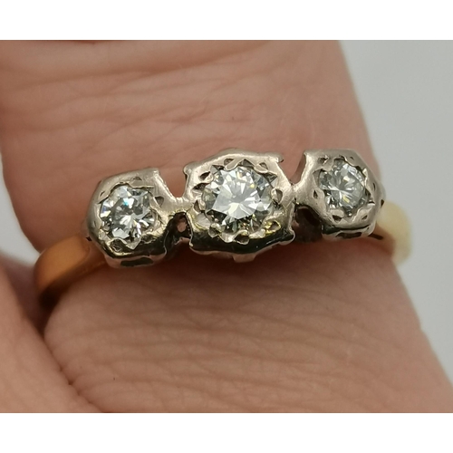 393 - An 18 carat gold three-stone diamond ring, the three graduated stones illusion-set in white gold, th... 