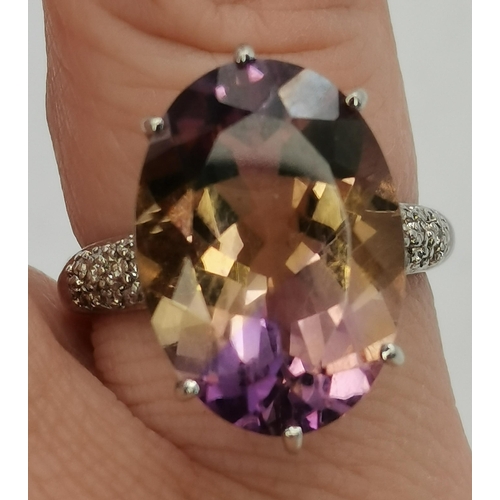 397A - A 9 carat white gold and lilac stone dress ring, the large oval stone in a raised and pierced claw s... 