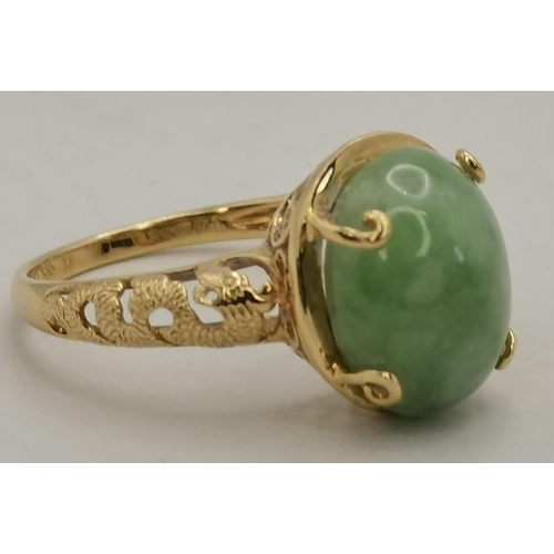 397D - A 14 carat gold jade ring, the loose oval cabochon stone to an open-backed claw setting, the mount a... 