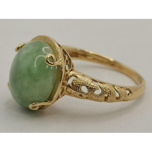 397D - A 14 carat gold jade ring, the loose oval cabochon stone to an open-backed claw setting, the mount a... 