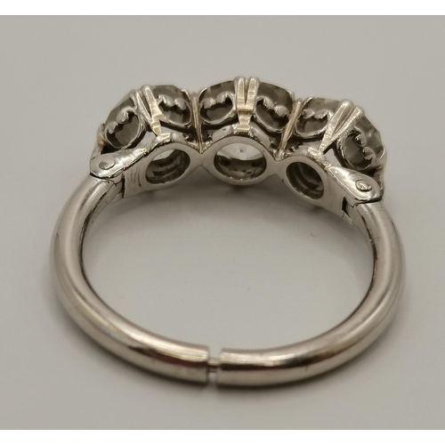 400 - An impressive platinum three-stone diamond ring, the old brilliant cut stones in C-scroll claw setti... 